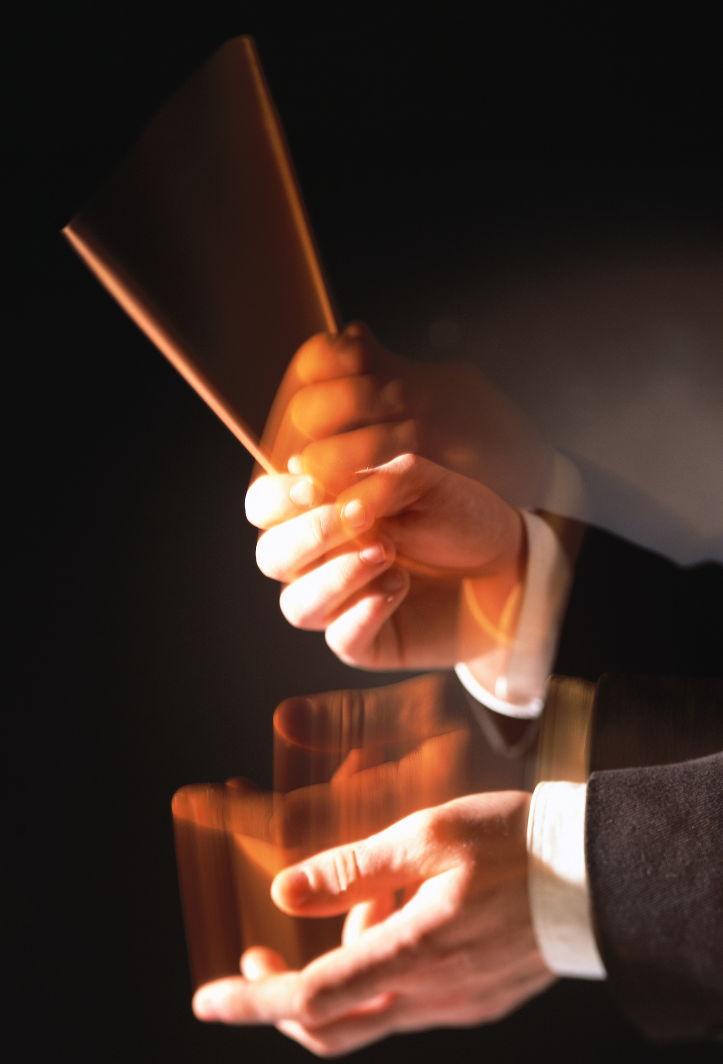 blurred shot of the hands of a musical conductor conducting